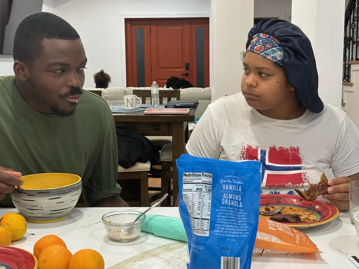 Timothy and Nicole share a relaxed breakfast at home, bowls and oranges on the table.